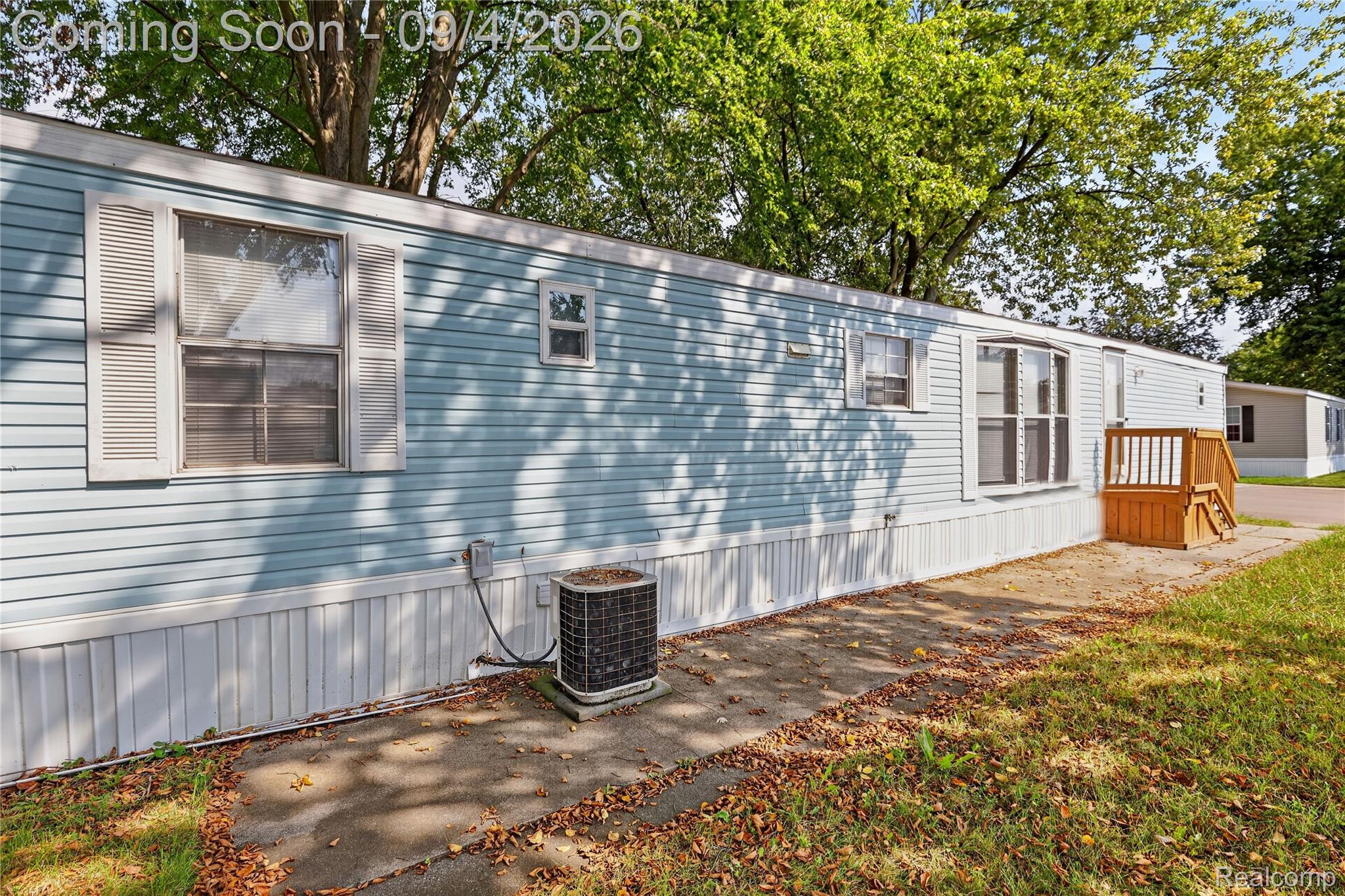 51074 Mott Road, Unit 200 Canton, MI 48188 - Photo 21 of 24 Light blue horizontal siding exterior with white window shutters