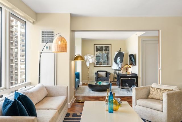 a living room with furniture and a large window