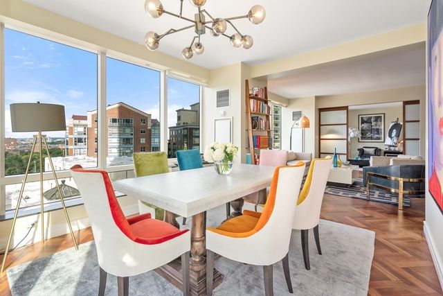 a view of a dining room with furniture wooden floor and chandelier