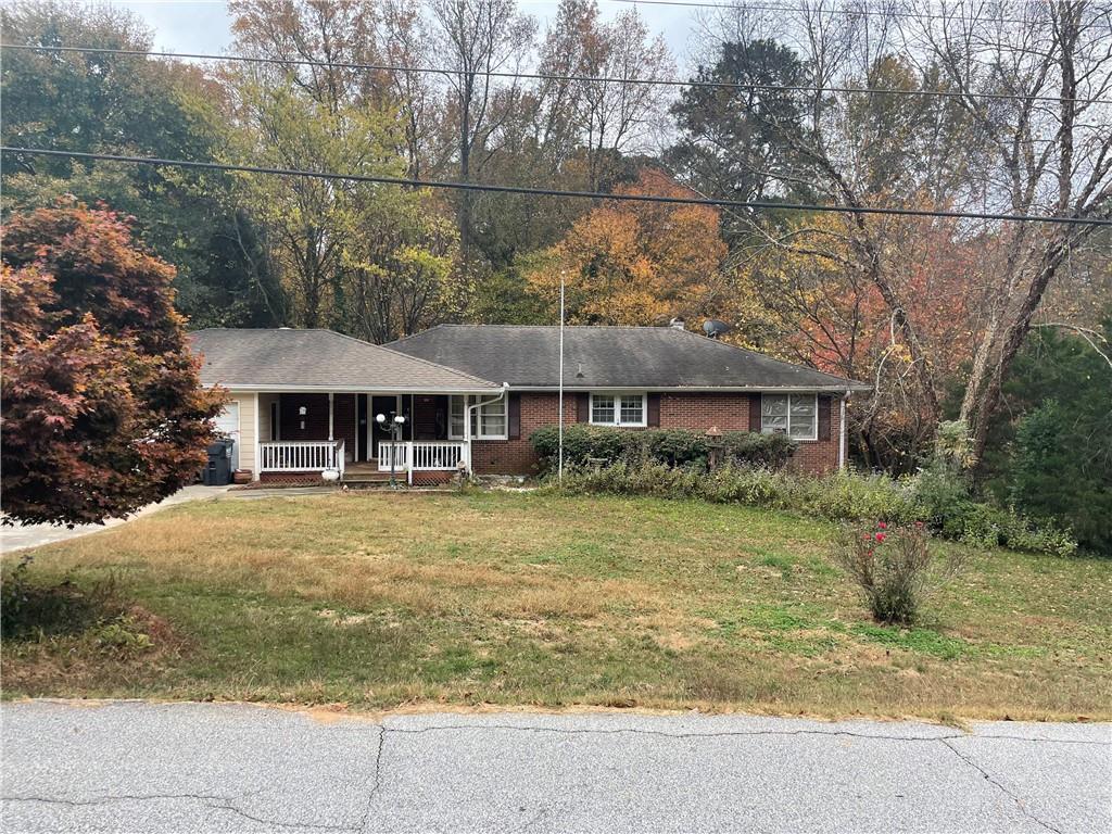 166 Valley Road Northwest Lawrenceville, GA 30044 - Photo 1 of 1 a front view of a house with a garden