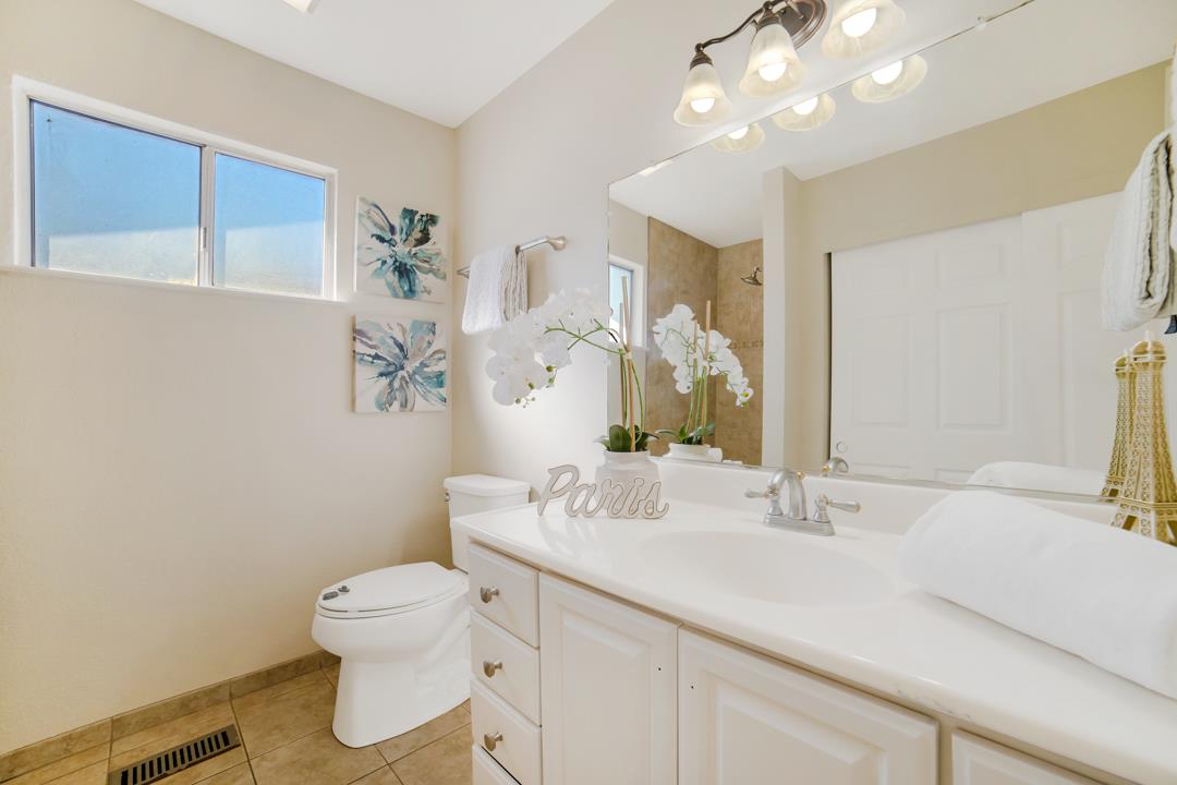 835 Fillippelli Drive Gilroy, CA 95020 - Photo 20 of 45 a bathroom with a sink a toilet and mirror