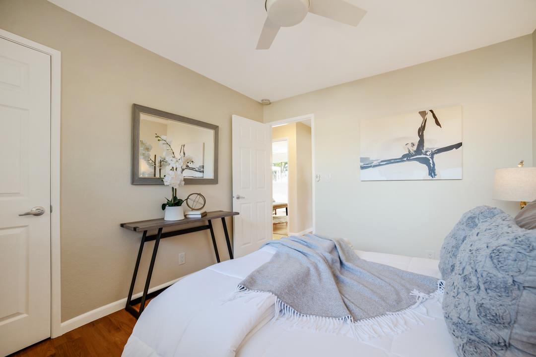 835 Fillippelli Drive Gilroy, CA 95020 - Photo 23 of 45 a bedroom with a bed and a chandelier