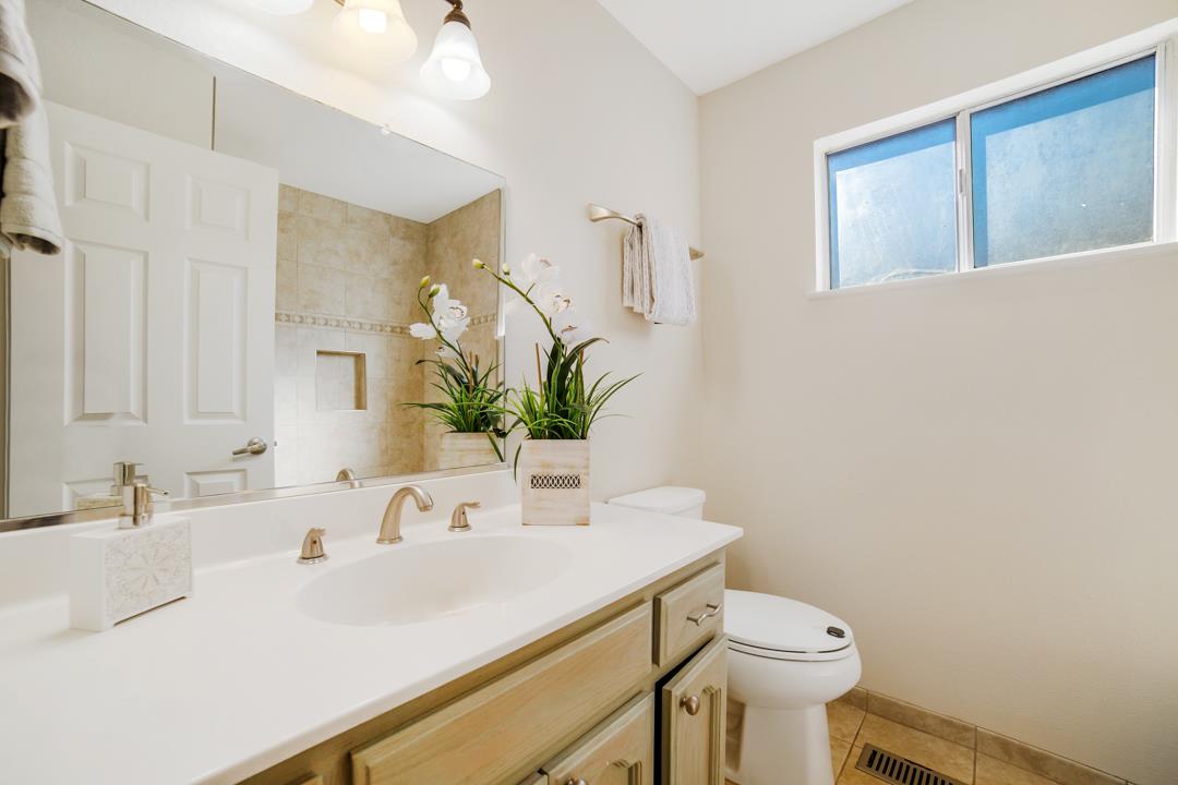 835 Fillippelli Drive Gilroy, CA 95020 - Photo 27 of 45 a bathroom with a sink a toilet and mirror