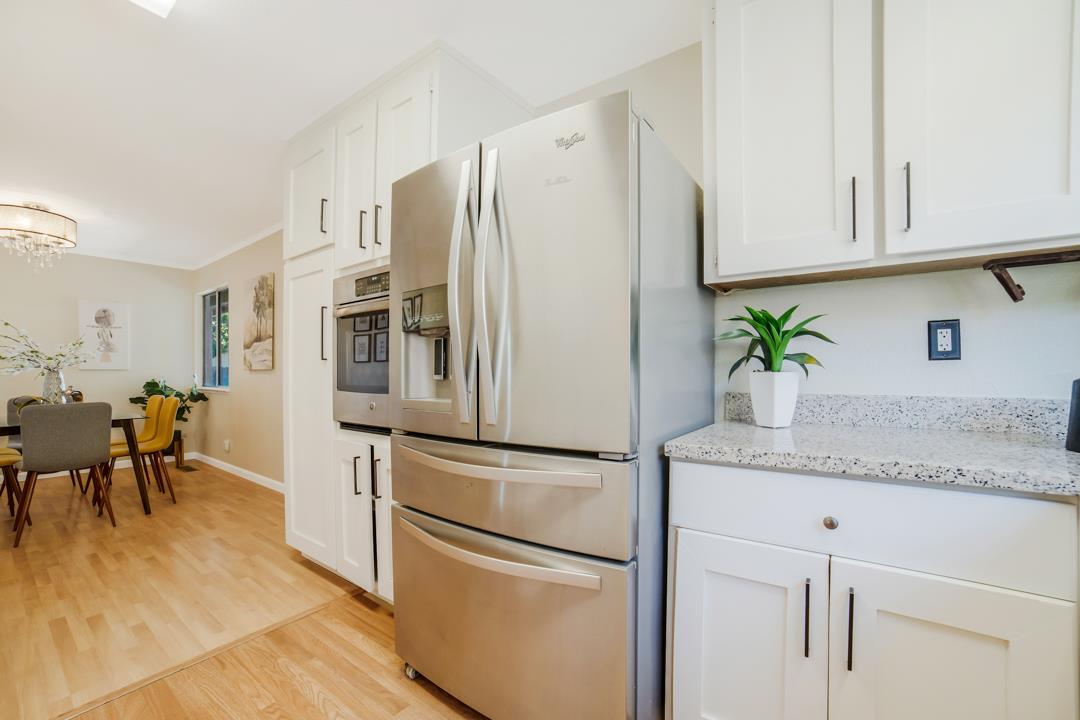 835 Fillippelli Drive Gilroy, CA 95020 - Photo 8 of 45 a kitchen with stainless steel appliances granite countertop white cabinets and a refrigerator