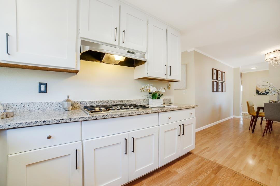 835 Fillippelli Drive Gilroy, CA 95020 - Photo 9 of 45 a kitchen with granite countertop white cabinets and white appliances