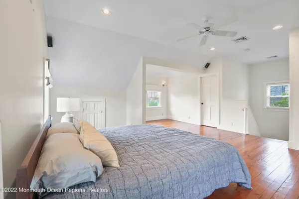 a spacious bedroom with a bed and a chandelier