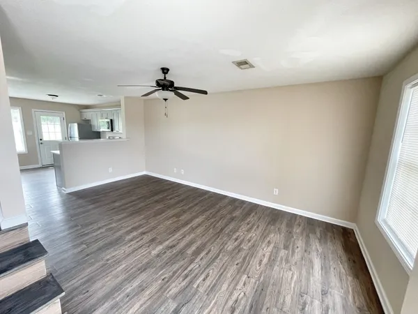 wooden floor in an empty room with a window