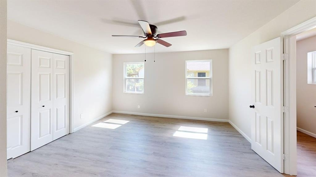 519 East Gandy Street Denison, TX 75021 - Photo 13 of 18 a view of an empty room with wooden floor and a window