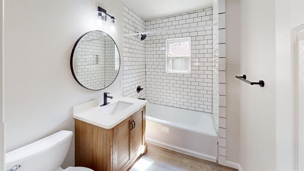 519 East Gandy Street Denison, TX 75021 - Photo 14 of 18 a bathroom with a sink a toilet and shower