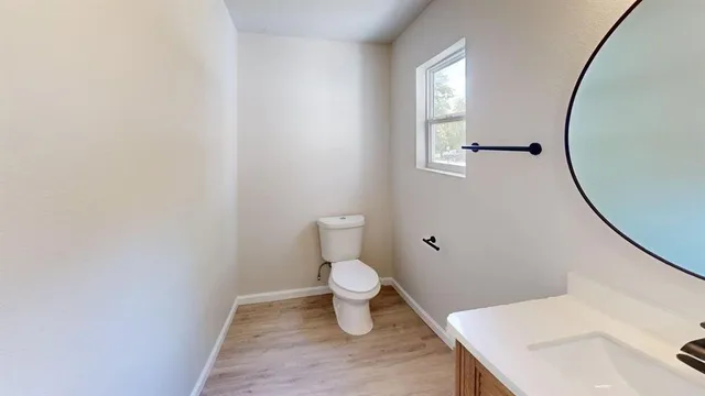 a bathroom with a sink toilet and a mirror