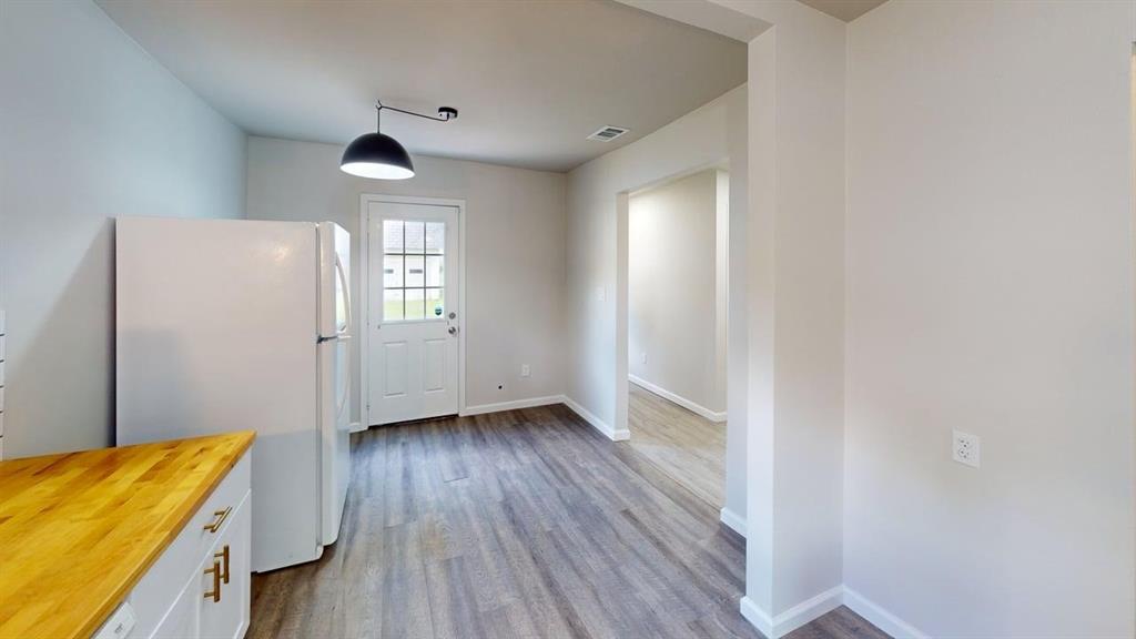 519 East Gandy Street Denison, TX 75021 - Photo 5 of 18 a view of a room with wooden floor and windows