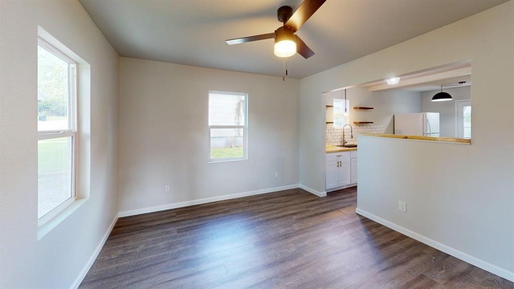 519 East Gandy Street Denison, TX 75021 - Photo 6 of 18 wooden floor in an empty room with a window
