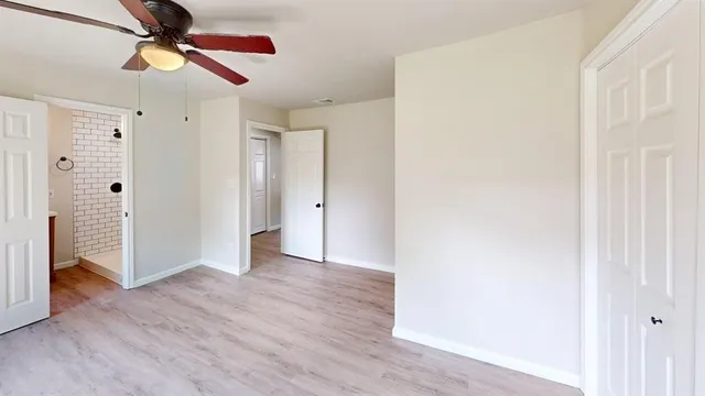 a view of an empty room with wooden floor