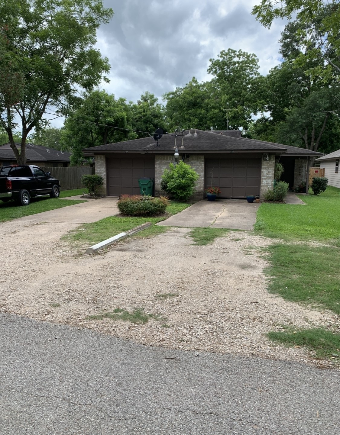 a view of a house with a yard and large tree
