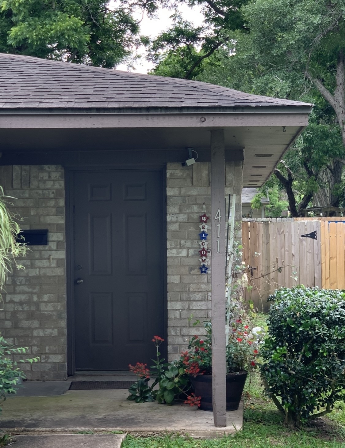 409-411 Hurst Place Angleton, TX 77515 - Photo 2 of 5 a front view of a house with plants