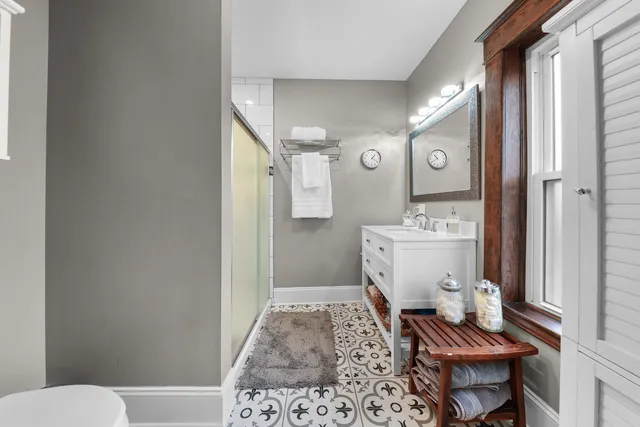 a bathroom with a toilet a sink and a mirror
