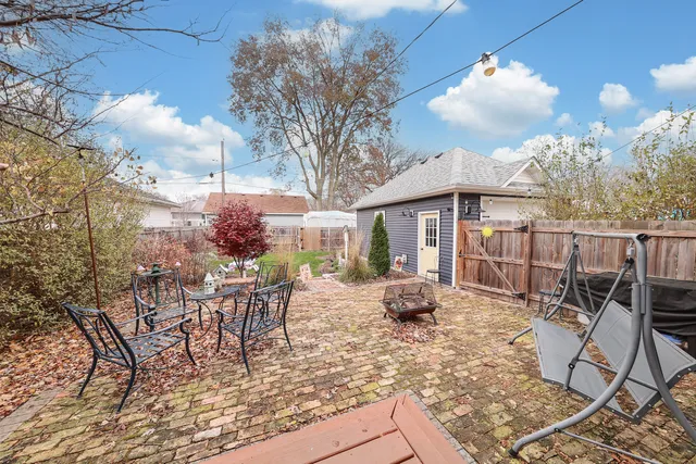 a view of a patio with table and chairs and potted plants