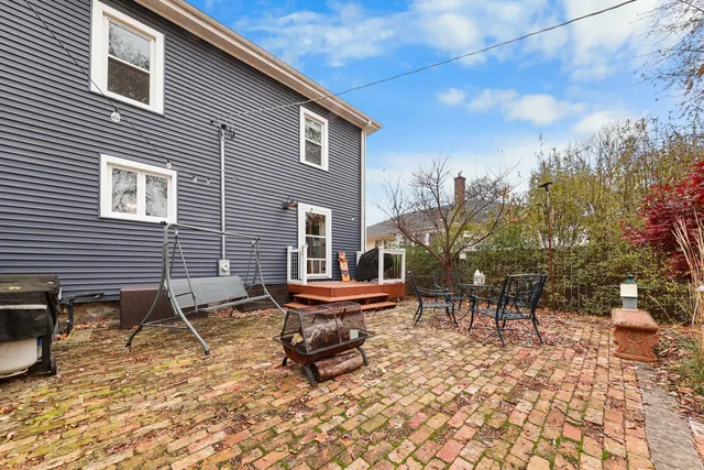 a backyard of a house with table and chairs