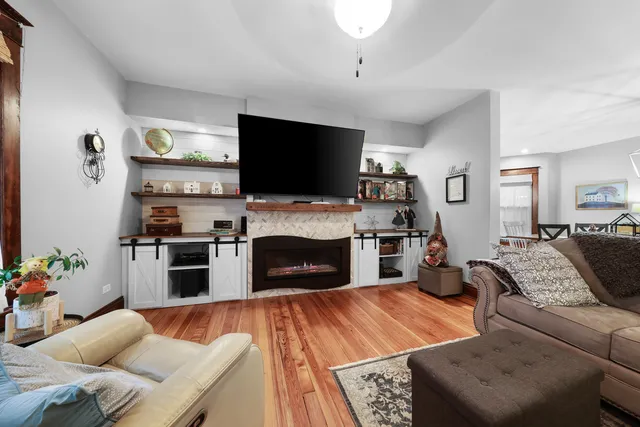a living room with furniture a fireplace and a flat screen tv