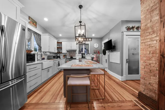 a kitchen with kitchen island a counter top space stainless steel appliances and cabinets