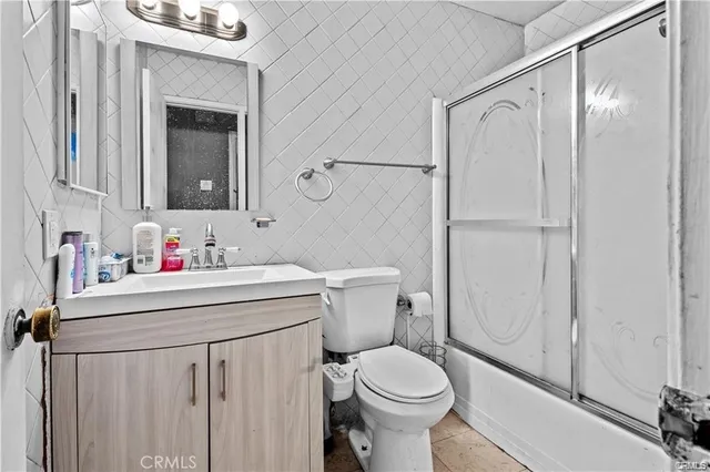 a bathroom with a sink mirror vanity and toilet