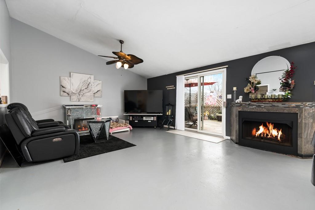 8180 Peebles Road Pittsburgh, PA 15237 - Photo 6 of 24 a living room with furniture a fireplace and a flat screen tv