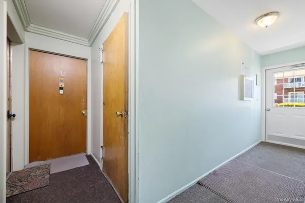 a view of hallway with bathroom