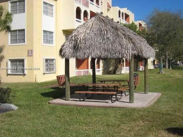 a view of a house with backyard and sitting area