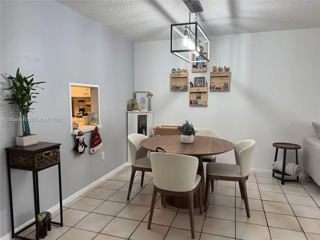 a view of a room with furniture and wooden floor
