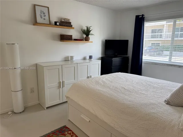 a bedroom with a bed and a television