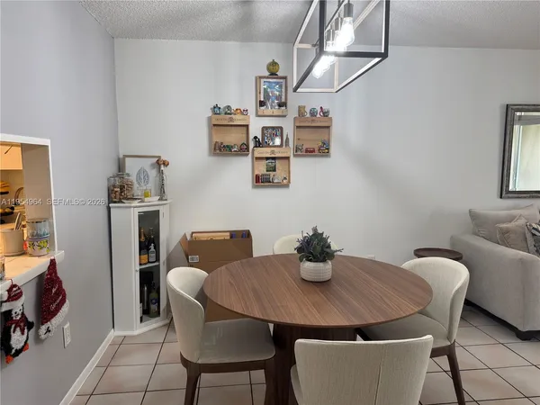 a dining room with furniture and window