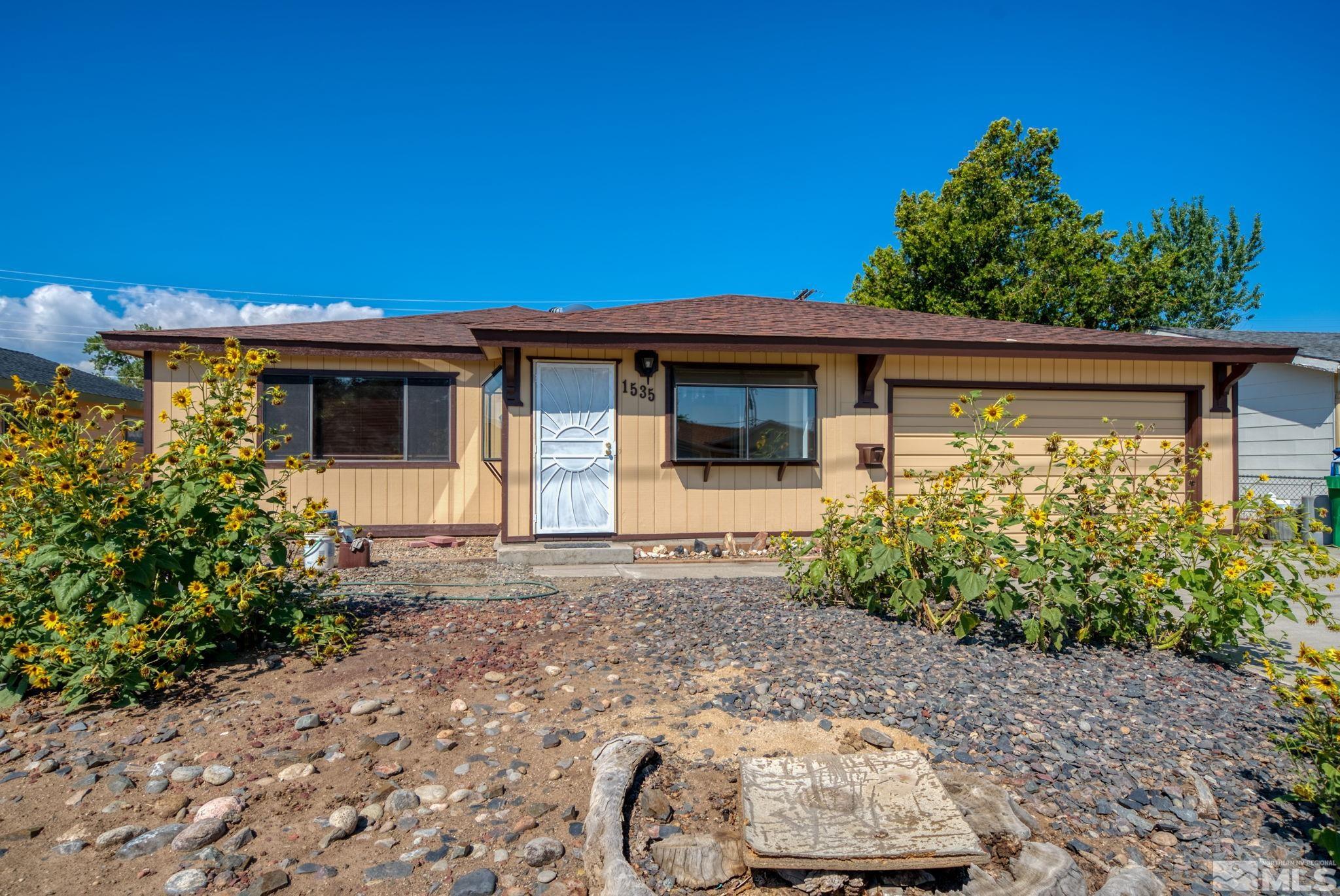 1535 Harvard Way Reno, NV 89502 - Photo 1 of 26 a front view of a house with garden