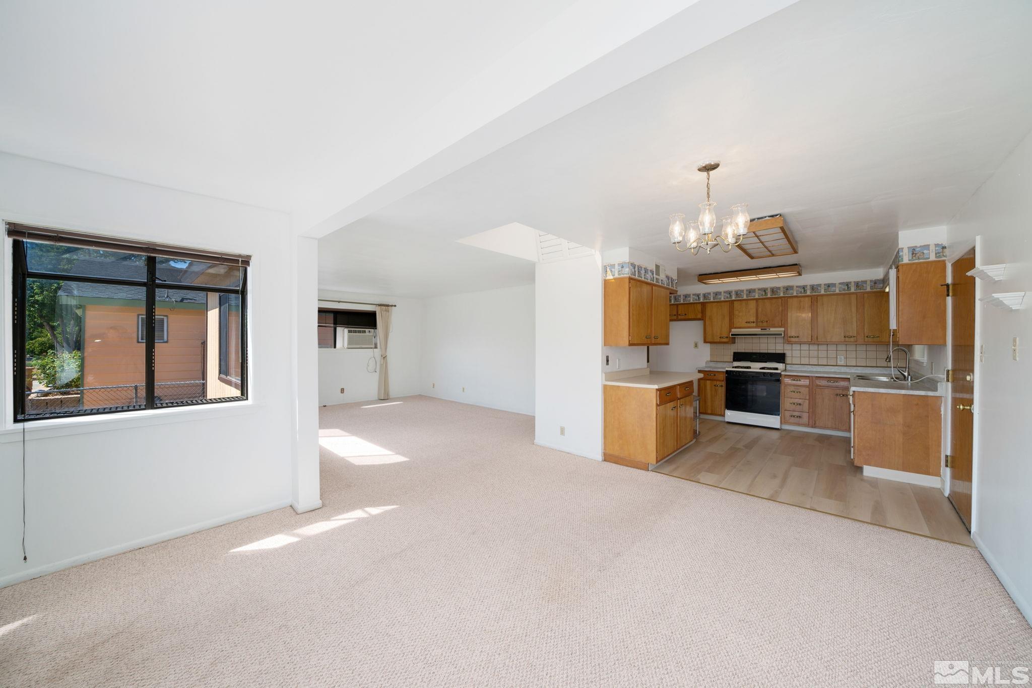 1535 Harvard Way Reno, NV 89502 - Photo 6 of 26 a view of a kitchen with wooden floor and stainless steel appliances