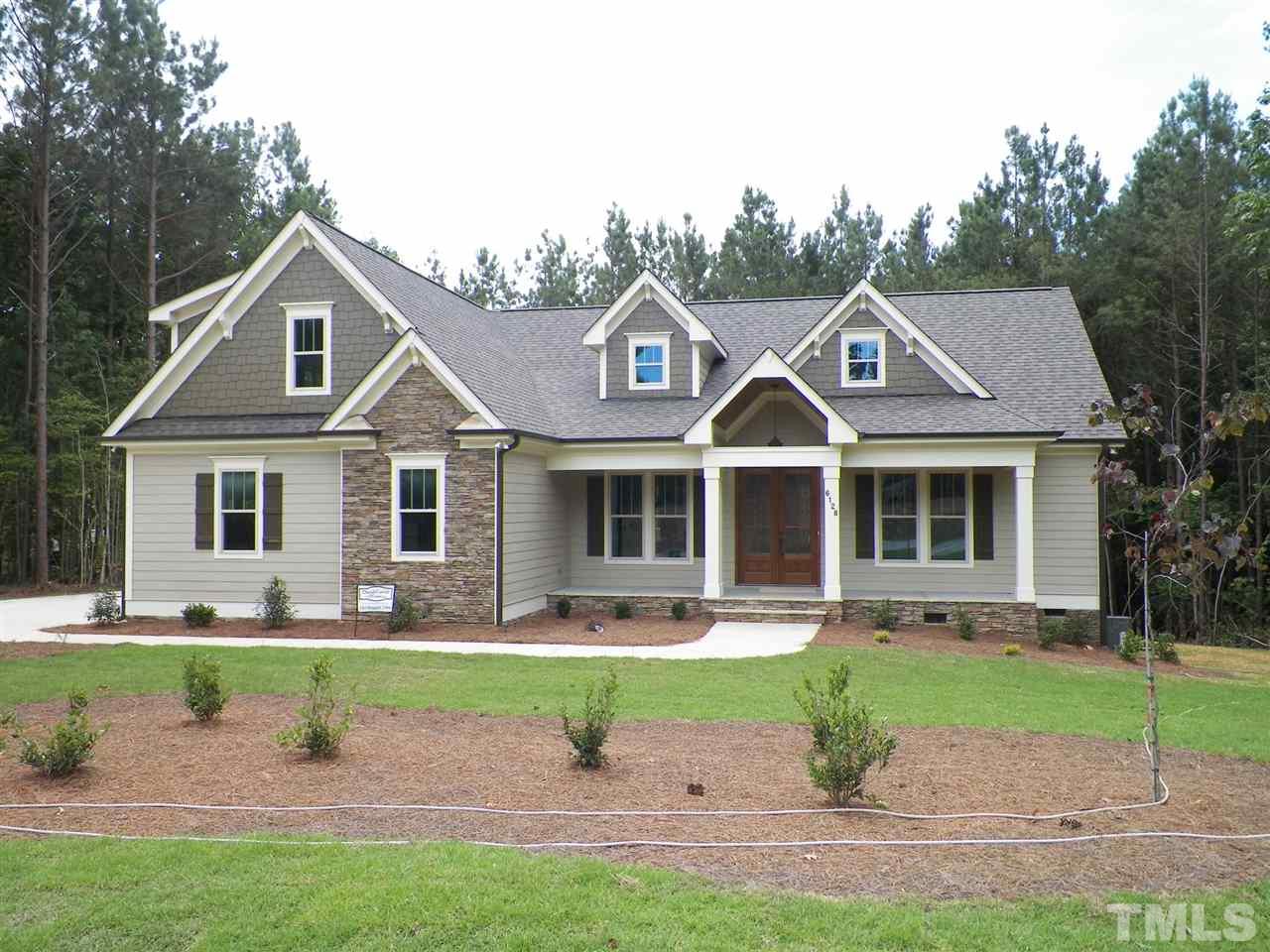 6128 Spring Branch Circle Raleigh, NC 27603 - Photo 1 of 25 a front view of a house with garden