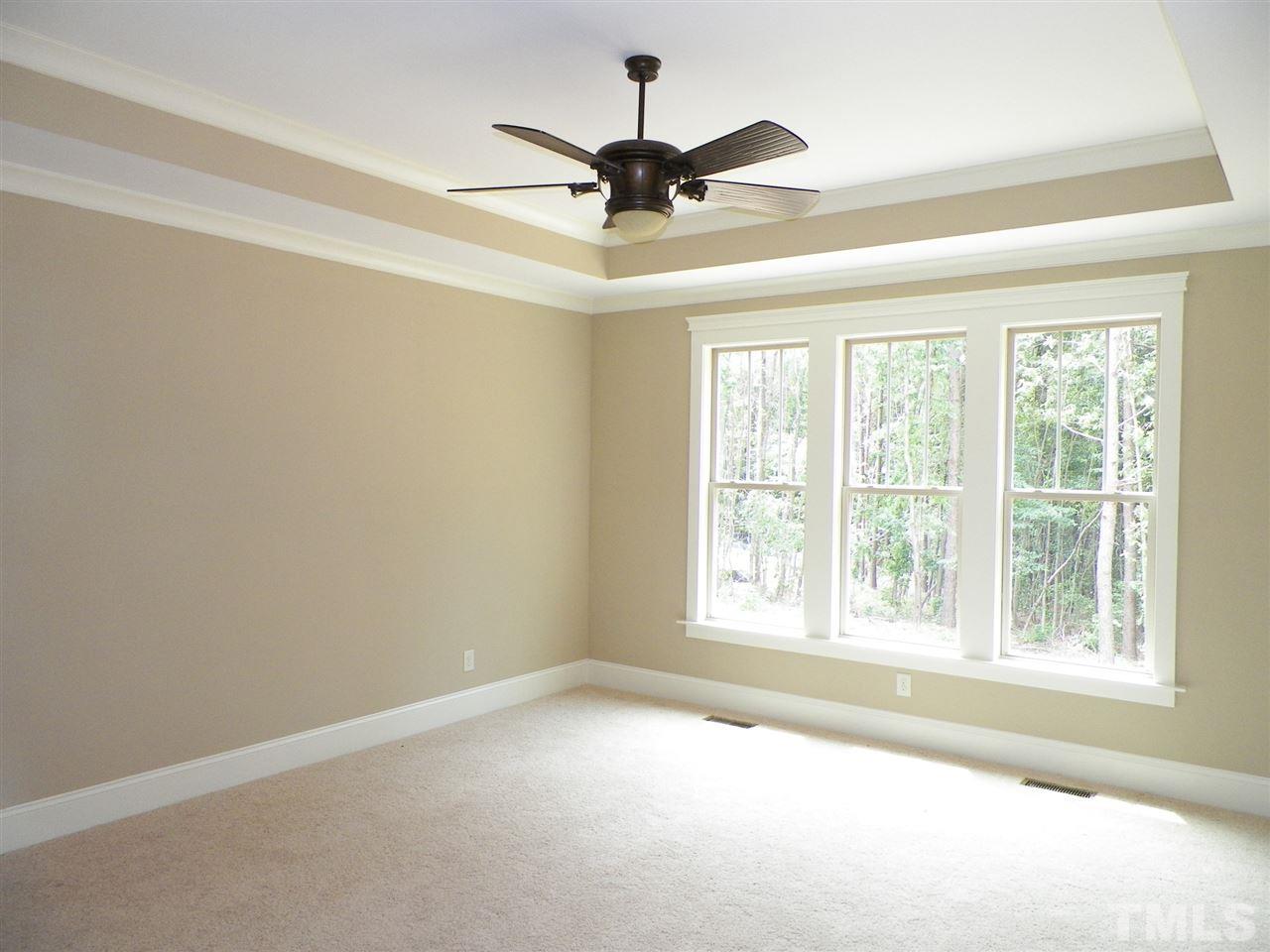 6128 Spring Branch Circle Raleigh, NC 27603 - Photo 11 of 25 an empty room with a ceiling fan and window