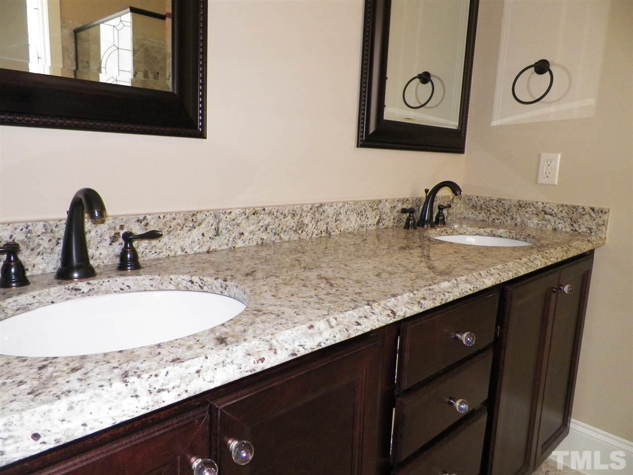 6128 Spring Branch Circle Raleigh, NC 27603 - Photo 12 of 25 a bathroom with a sink and a mirror