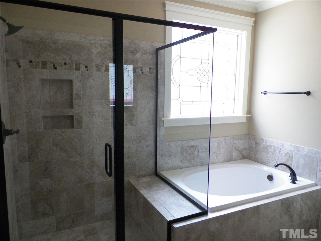 6128 Spring Branch Circle Raleigh, NC 27603 - Photo 14 of 25 a bathroom with a bathtub and a shower