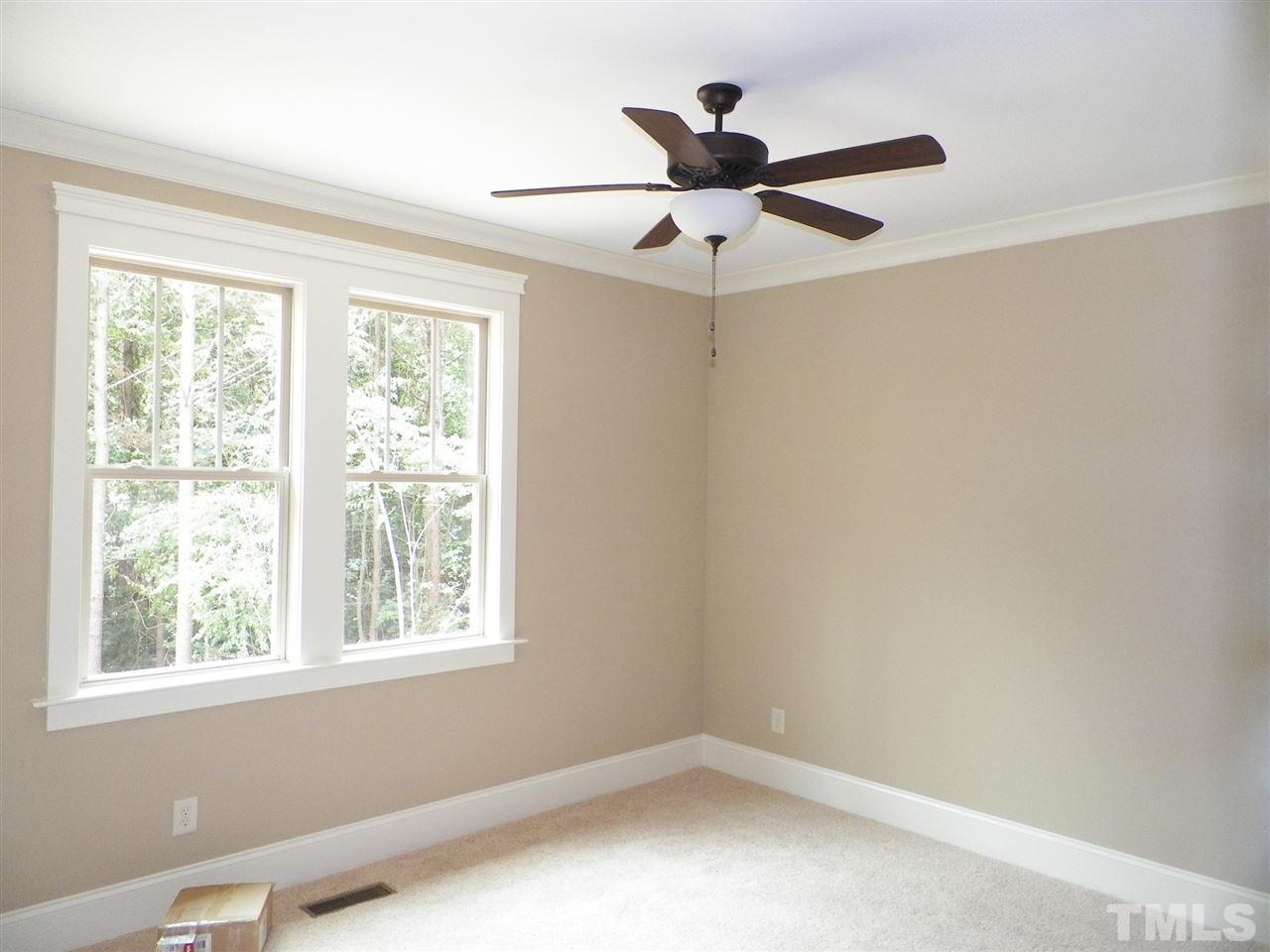 6128 Spring Branch Circle Raleigh, NC 27603 - Photo 15 of 25 an empty room with a window and a fan