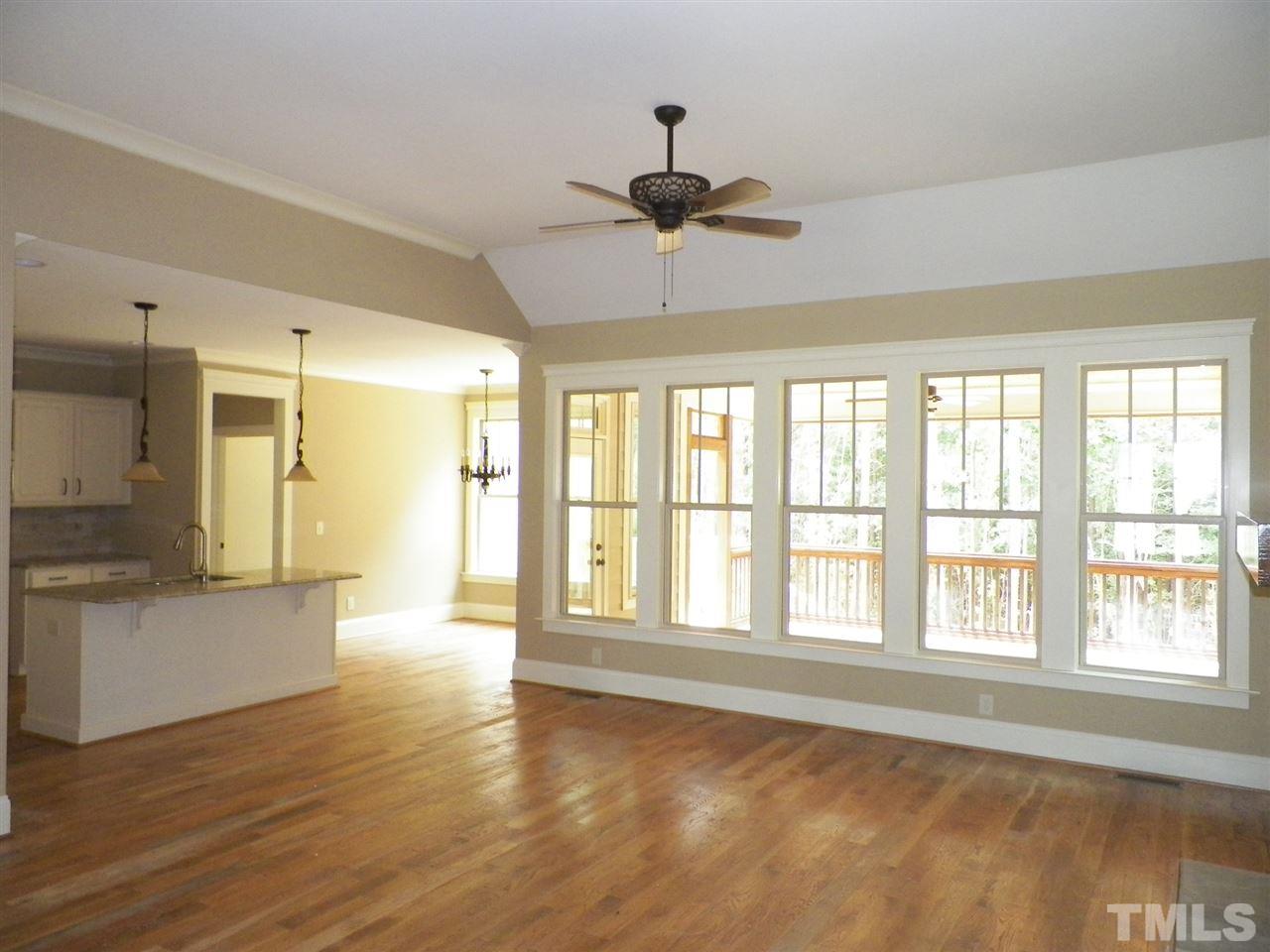 6128 Spring Branch Circle Raleigh, NC 27603 - Photo 5 of 25 a view of an empty room with a window and wooden floor