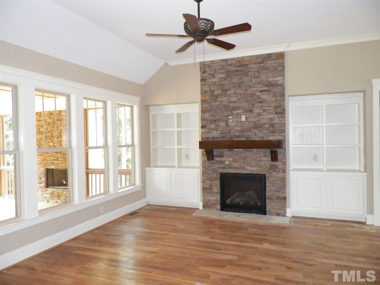 6128 Spring Branch Circle Raleigh, NC 27603 - Photo 6 of 25 a view of an empty room with a fireplace and a window