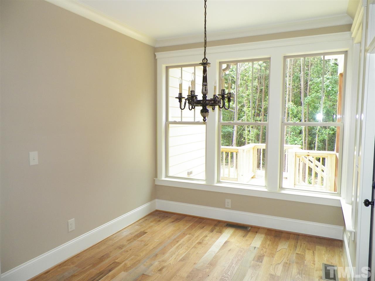 6128 Spring Branch Circle Raleigh, NC 27603 - Photo 8 of 25 a view of an empty room with wooden floor and a window