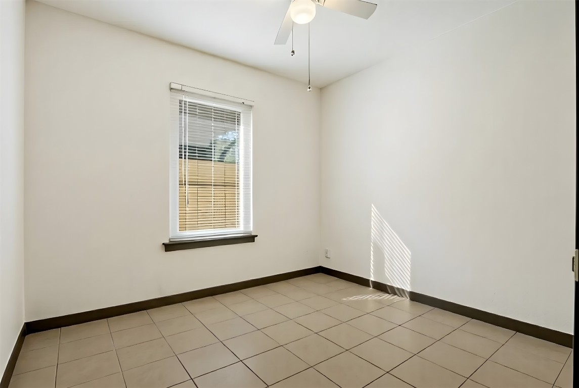904 Plateau Circle, Unit A Austin, TX 78745 - Photo 14 of 26 a view of an empty room with a window