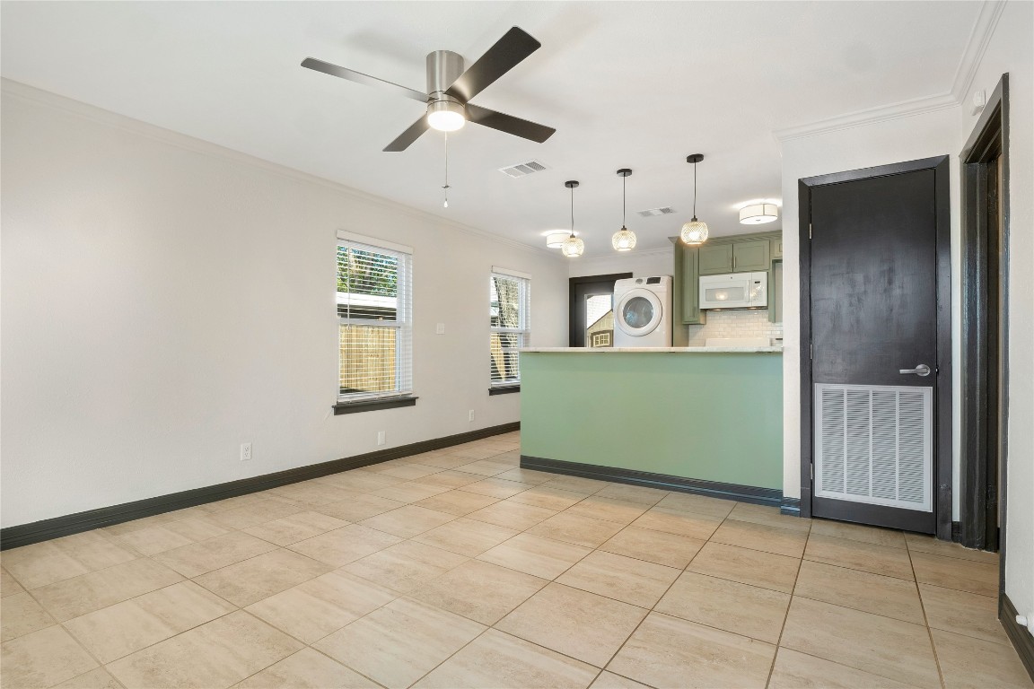 904 Plateau Circle, Unit A Austin, TX 78745 - Photo 7 of 26 an empty room with a kitchen and a window