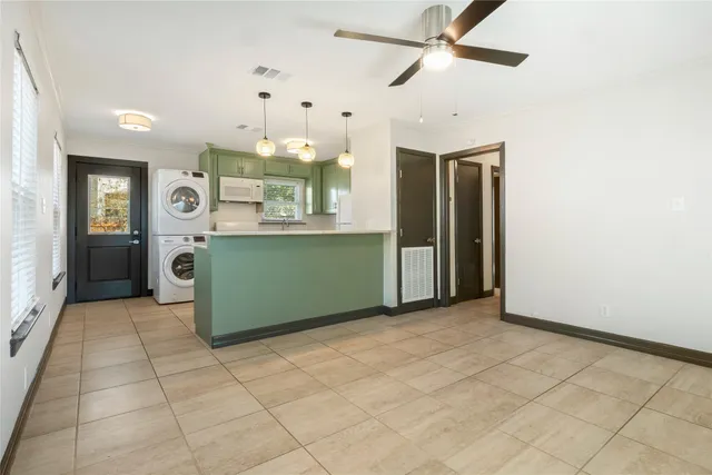 a view of a kitchen with a sink and cabinets