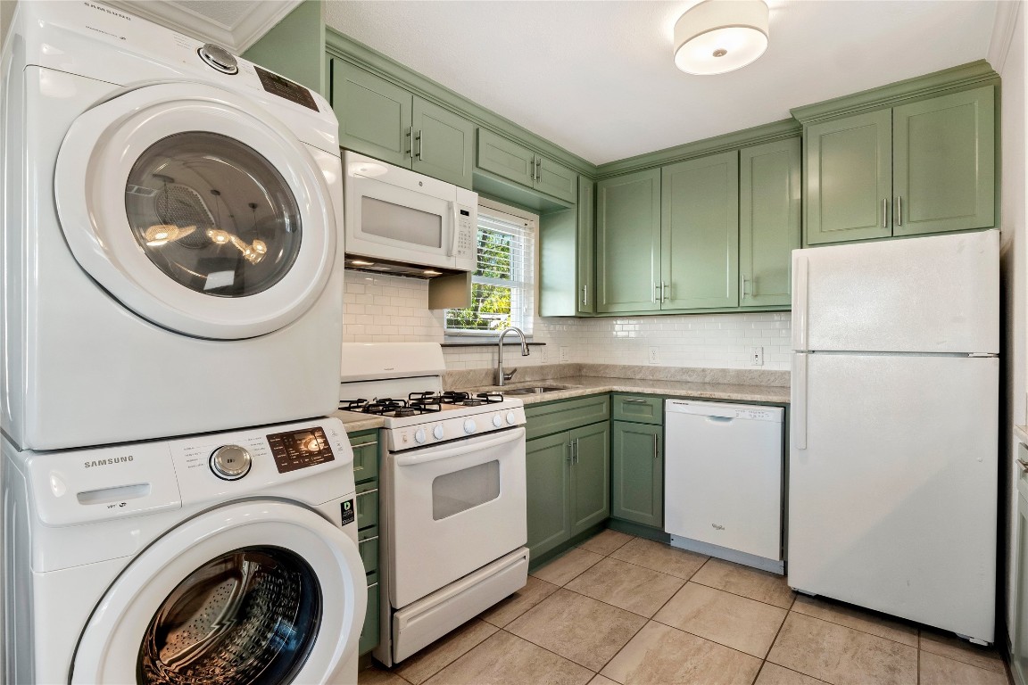904 Plateau Circle, Unit A Austin, TX 78745 - Photo 10 of 26 a kitchen with a refrigerator sink stove and cabinets