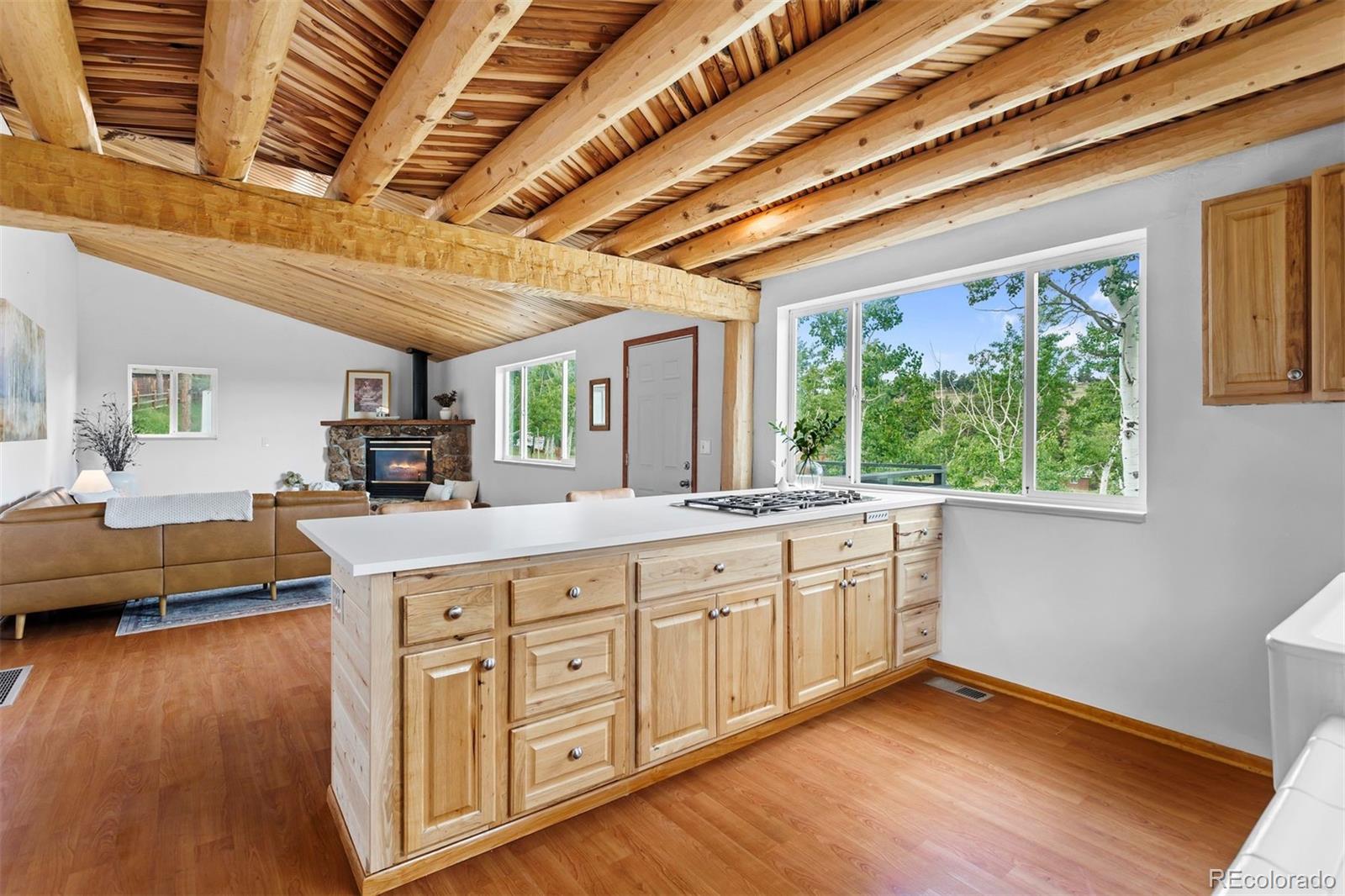 616 South Pine Drive Bailey, CO 80421 - Photo 15 of 50 a large kitchen with kitchen island granite countertop wooden floors and a large window