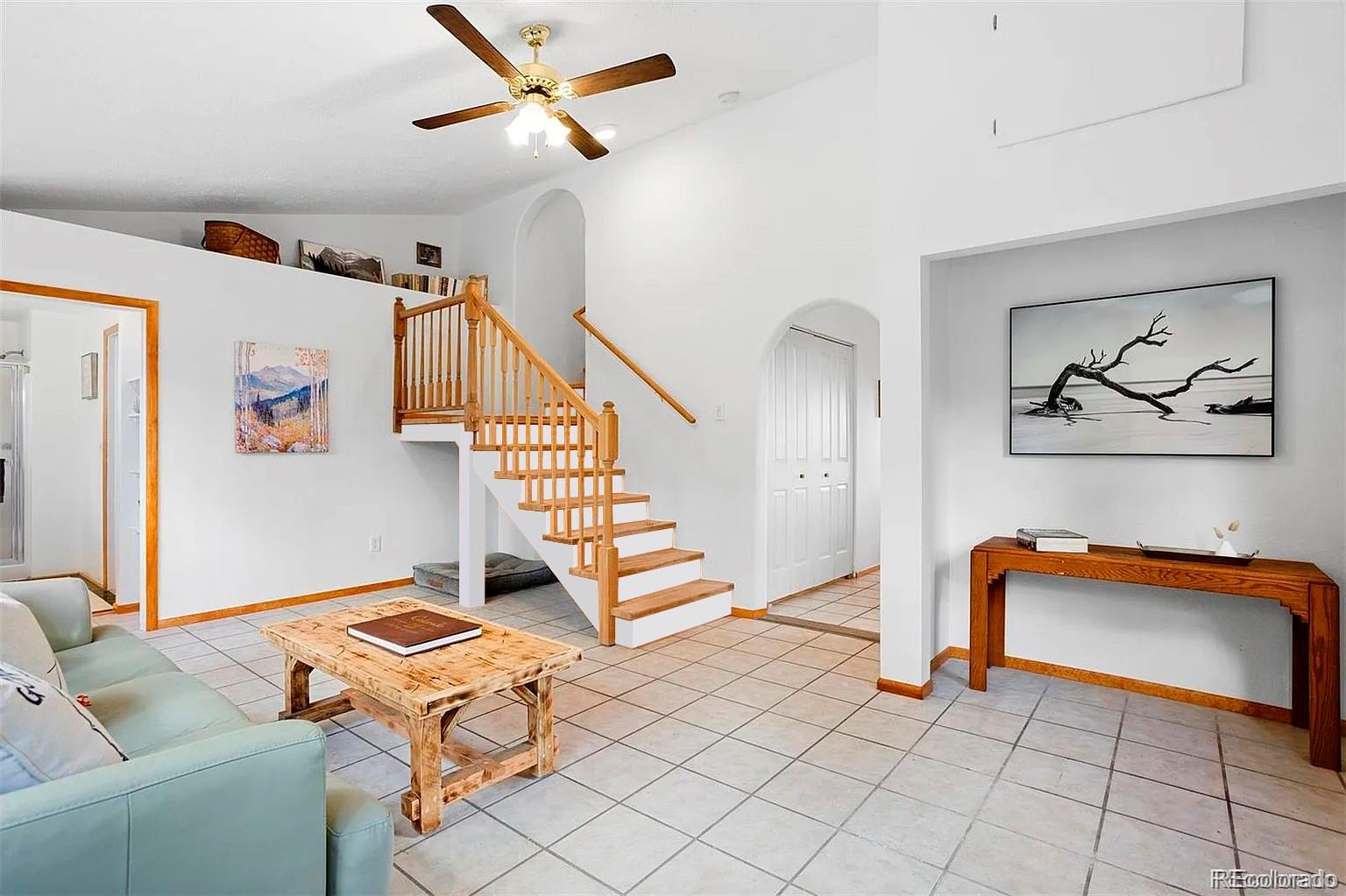 616 South Pine Drive Bailey, CO 80421 - Photo 19 of 50 a living room with blue walls and stairs