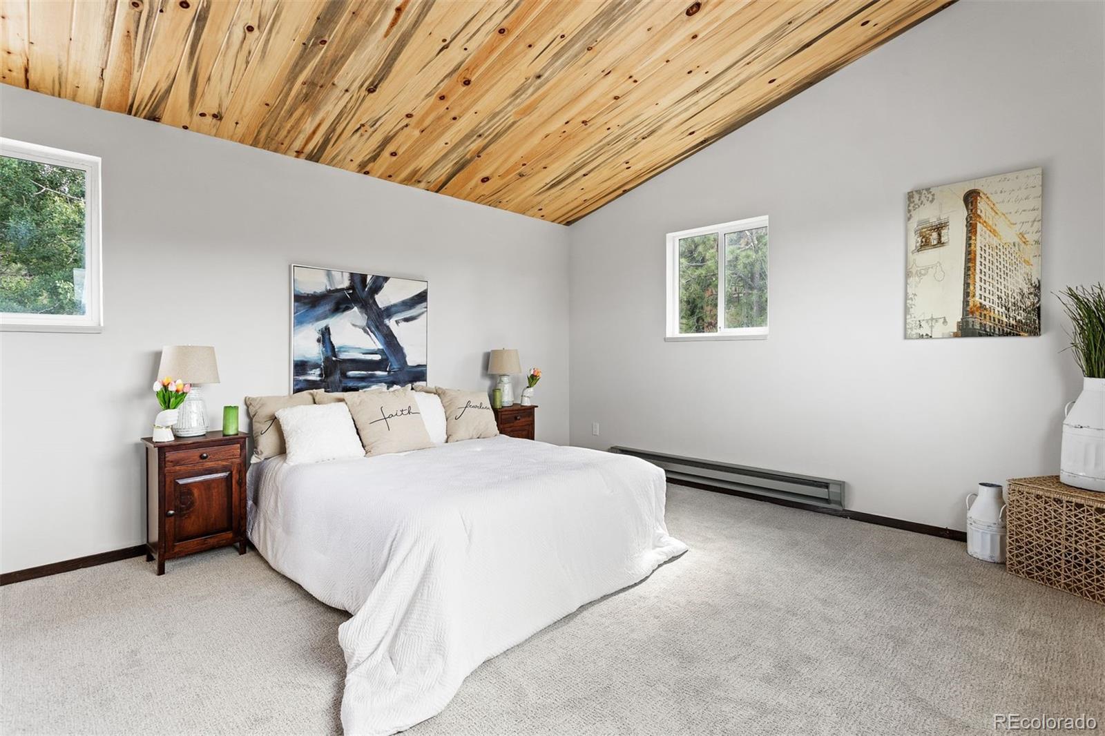 616 South Pine Drive Bailey, CO 80421 - Photo 28 of 50 a bedroom with a bed and wooden floor