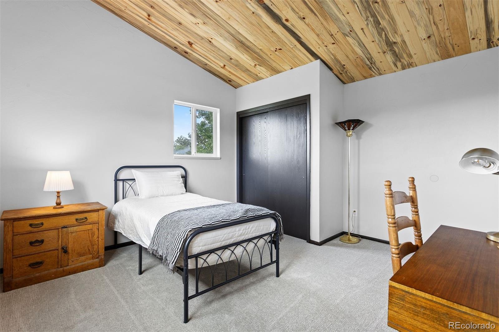 616 South Pine Drive Bailey, CO 80421 - Photo 30 of 50 a bedroom with a bed chair and a desk