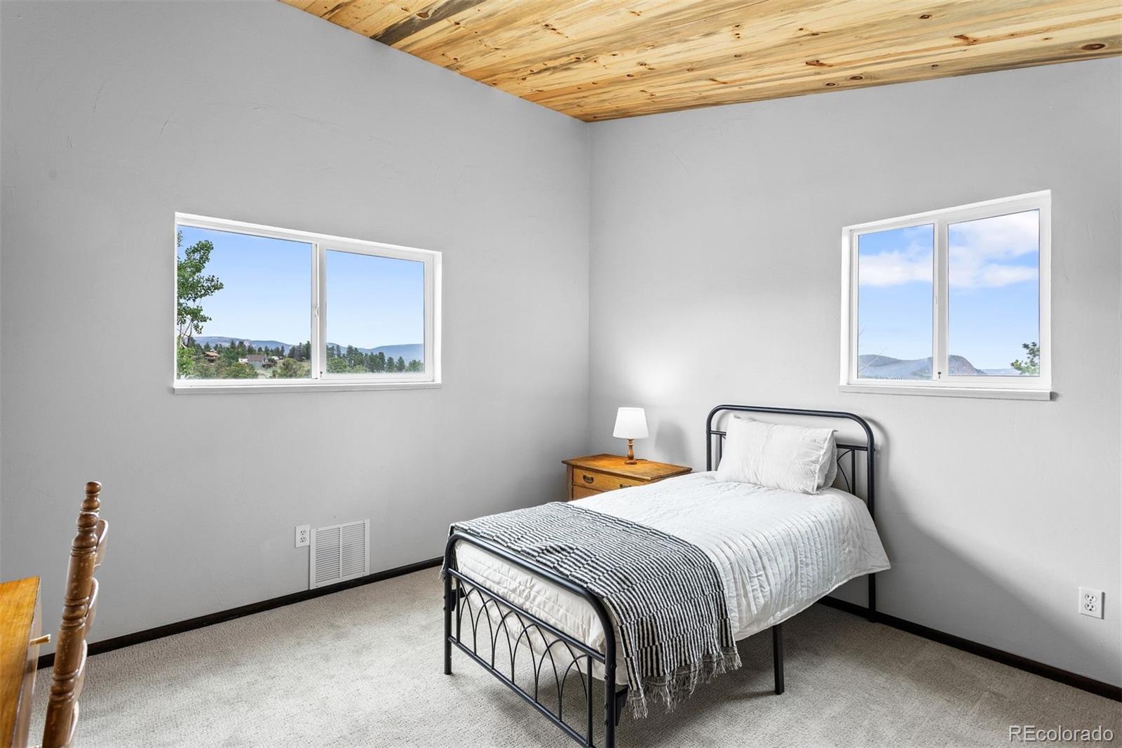 616 South Pine Drive Bailey, CO 80421 - Photo 31 of 50 a bedroom with a bed and window